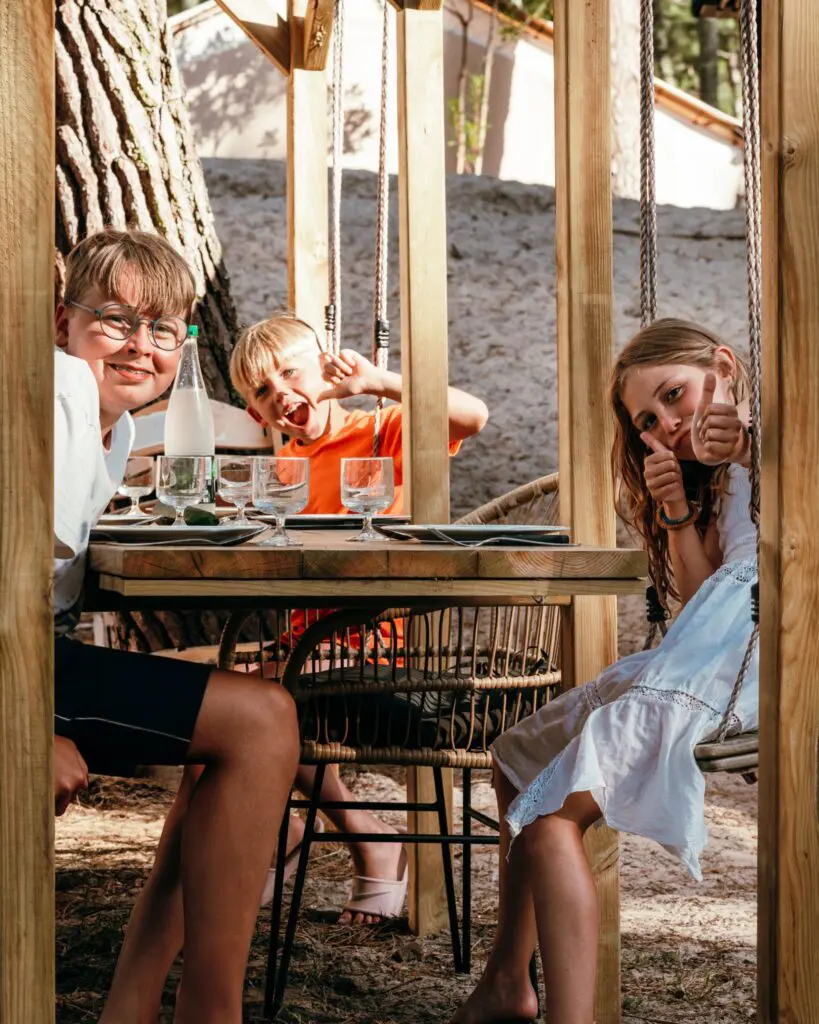 three children having fun at an outdoor restaurant