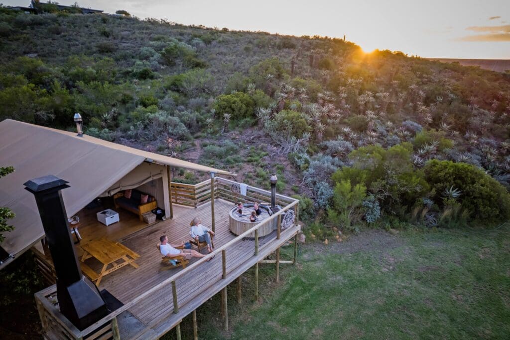aerial view of glamping tent with hot tub at sunset
