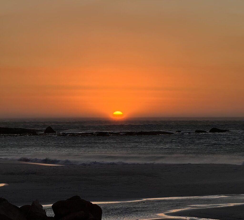 vibrant sunset over the ocean with a sandy beach