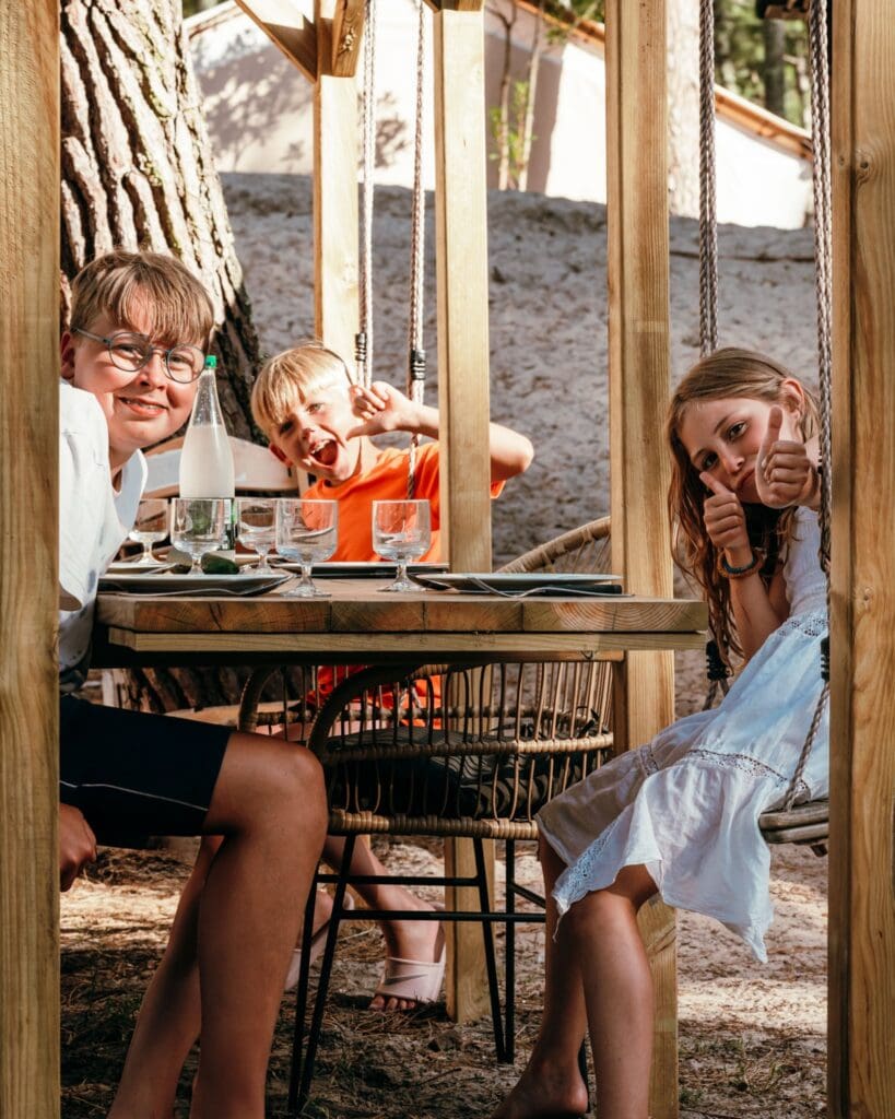 three children having fun at an outdoor restaurant